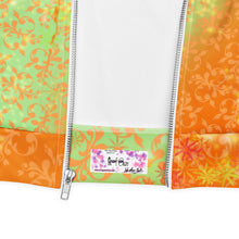 Load image into Gallery viewer, Colorful fabric with floral patterns and a visible brand label on a white background