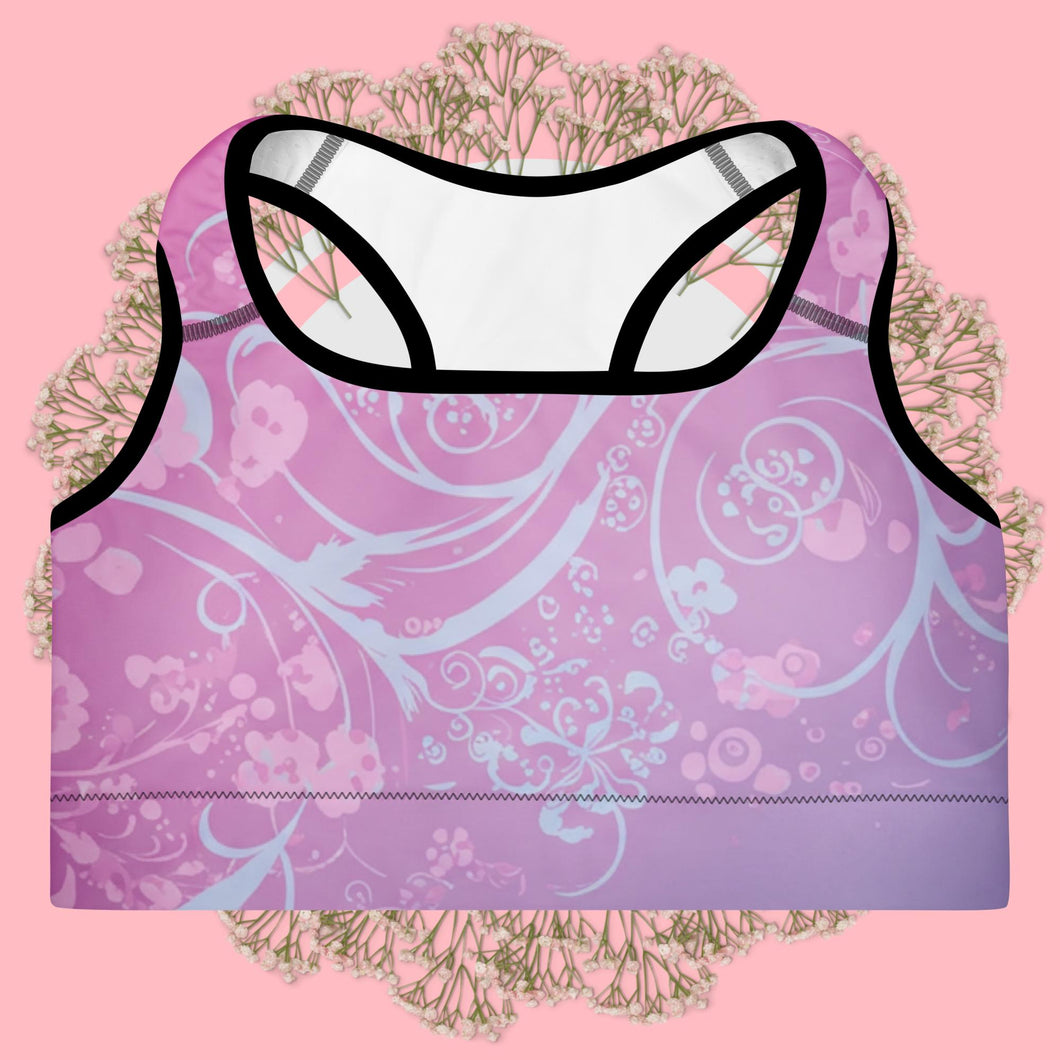 Purple sports bra with floral pattern on a pink background