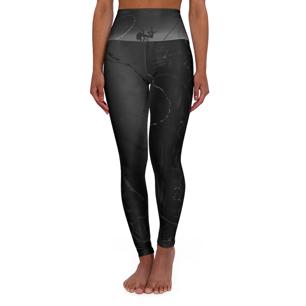 A Silhouette of a woman laying with a leg kick up in the air.  [High Waisted Yoga Shorts/wPockets] Gray and black. With gray swirls. 